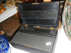 An old ebonised writing box with key.