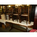 A long oak dining table and a set of eight pad foot chairs, COLLECT ONLY.