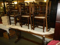 A long oak dining table and a set of eight pad foot chairs, COLLECT ONLY.