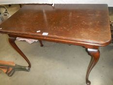 A mahogany fold over table. COLLECT ONLY.