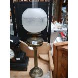 A brass oil lamp complete with shade, COLLECT ONLY.