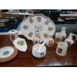 Eleven pieces of Goss crested china.