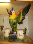 A large ceramic parrot with two feeding bowls. COLLECT ONLY.
