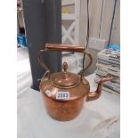 A Victorian copper kettle.