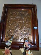 A framed copper plaque depicting birds.