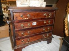 A small four drawer chest with drop handles. COLLECT ONLY.