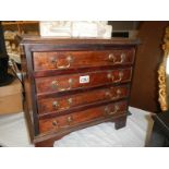 A small four drawer chest with drop handles. COLLECT ONLY.