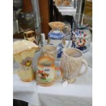 A mixed lot of jugs including Beswick, Carlton ware etc.,