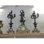 A Three piece French clock garniture - The clock with enamel dial and surmounted figure,