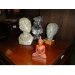 Three busts including Roman soldier and a Buddha.