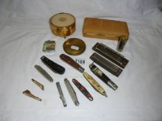 A mixed lot including pen knives, harmonica's, compact etc.,