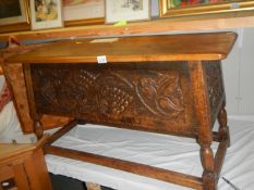A heavy oak carved front coffer/chest with vine/grape decoration, COLLECT ONLY.
