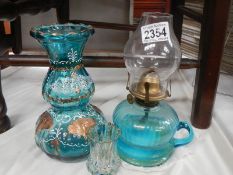 A Victorian blue glass hand oil lamp.