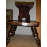 An early 20th century wooden stool and a miniature carved table.