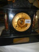 An early 20th century slate mantel clock in working order.