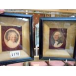 A pair of framed and glazed print portraits of George Washington and Martha Washington.