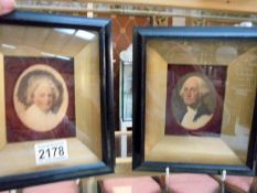 A pair of framed and glazed print portraits of George Washington and Martha Washington.