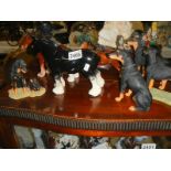Three horse and four dog figures.