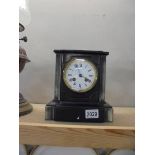A heavy black mantel clock.