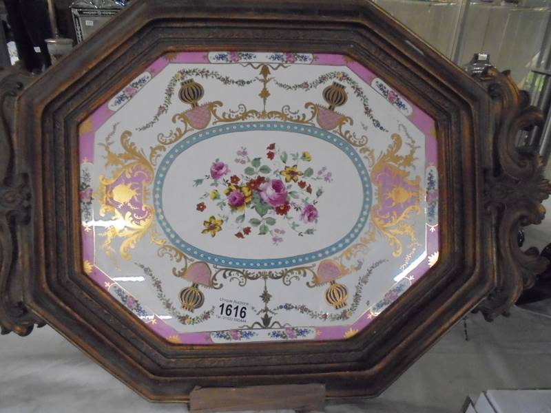 A gilt framed ceramic tray.