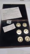 A cased set of six gold plated Heroes of WW2 coins with certificate.