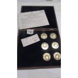 A cased set of six gold plated Heroes of WW2 coins with certificate.