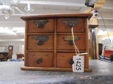 A six drawer spice chest.