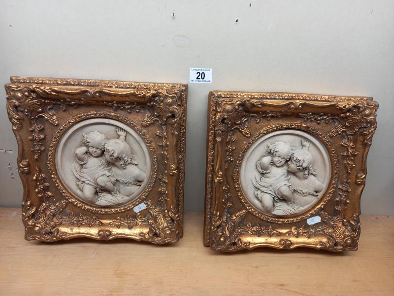 2 gilt framed classical resin plaques of children (28cm x 28cm)