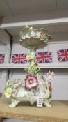 A continental porcelain table centrepiece decorated with cherub (cherub hands a/f)