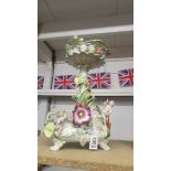 A continental porcelain table centrepiece decorated with cherub (cherub hands a/f)