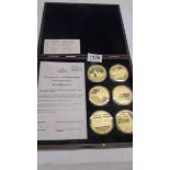 A cased set of six Rule Britannia gold plated coins with certificate.