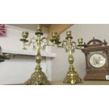 A pair of ornate brass candelabra.