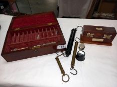A vintage tray test kit in a wooden box, 4 bottles and a mahogany box balance scales etc