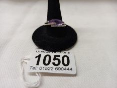 A 9ct white gold ring set amethyst and seven diamonds, size N, 4.4 grams.