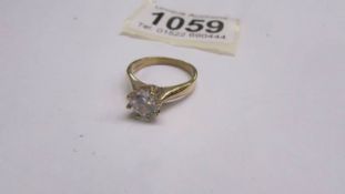 A 9ct gold ring set with a white stone, size L half.