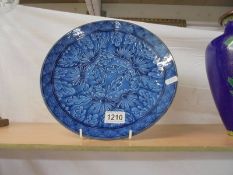 A Chinese blue glazed plate, 28 cm.