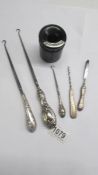 3 silver handled button hooks, two other silver handled items and a hair pot.