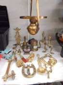 A mixed lot of brassware including fire dogs, bells, hanging oil lamp etc.,