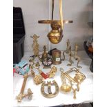 A mixed lot of brassware including fire dogs, bells, hanging oil lamp etc.,