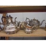 Two silver plate teapots and a sugar bowl, milk jug and water jug.