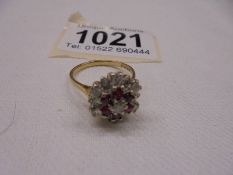 An 18ct gold diamond and ruby floral ring, size N, 5.1 grams.