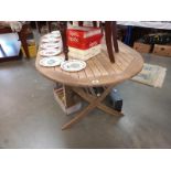 An oval teak garden table (as new)