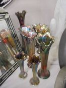 Nine various sized Carnival glass vases.