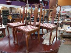 A set of 4 Edwardian high back dining chairs on pad feet