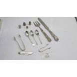 Three silver tea spoons, silver sugar nips, silver thimbles, silver handled knife and fork etc.,