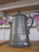 A large antique pewter lidded jug.