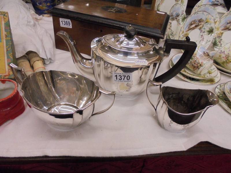 A three piece silver plate tea set marked 207.