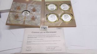 A cased set of four 'Popes of the Modern Era' coins with certificate.