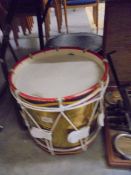 A gold coloured drum in case.