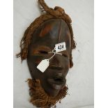 An African Mwana Pwo style mask, 30 x 19 cm.